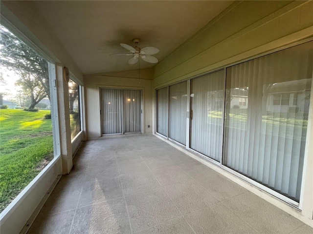 unfurnished sunroom with ceiling fan
