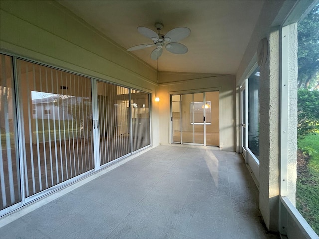 unfurnished sunroom featuring ceiling fan