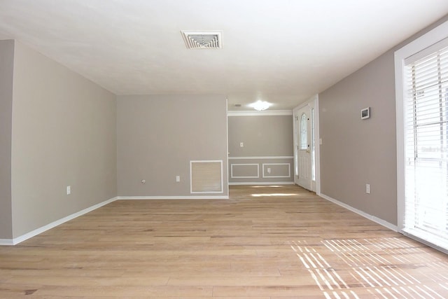 12210 Quail Run Row, Hudson, FL 34667 - empty room featuring crown molding, baseboards, light wood-style flooring, and visible vents