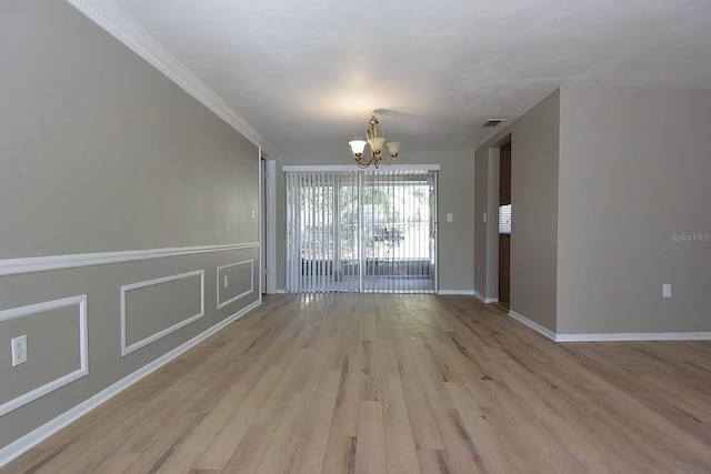 12210 Quail Run Row, Hudson, FL 34667 - interior space featuring crown molding, visible vents, light wood-style floors, baseboards, and a chandelier