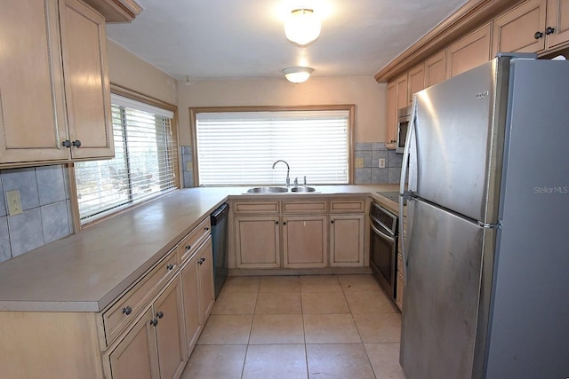 12210 Quail Run Row, Hudson, FL 34667 - kitchen featuring appliances with stainless steel finishes, tasteful backsplash, a sink, light countertops, and light tile patterned flooring