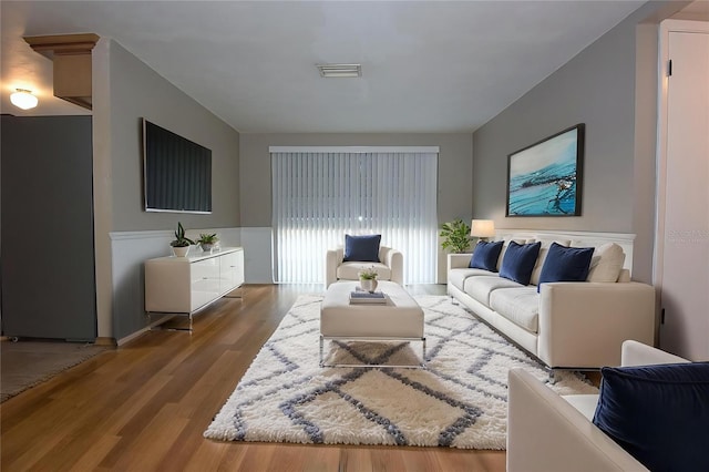 12210 Quail Run Row, Hudson, FL 34667 - living area with visible vents, wainscoting, and wood finished floors