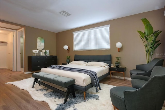 12210 Quail Run Row, Hudson, FL 34667 - bedroom with baseboards, visible vents, and light wood-type flooring