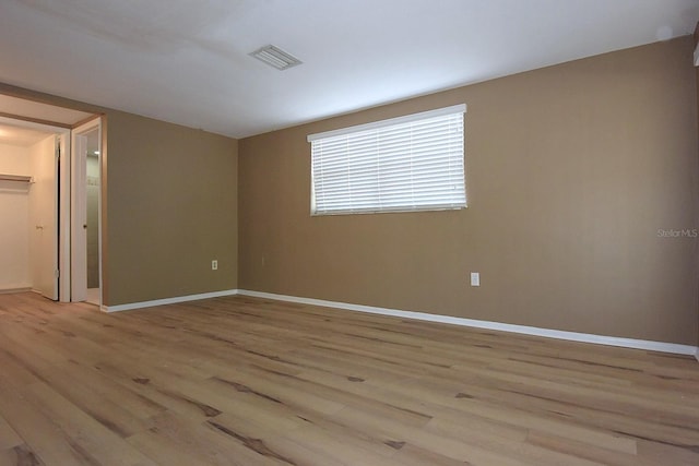 12210 Quail Run Row, Hudson, FL 34667 - empty room featuring baseboards, light wood-style flooring, and visible vents