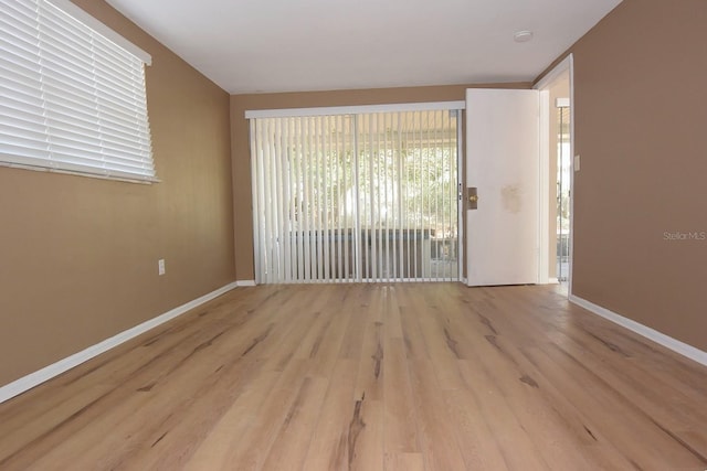 12210 Quail Run Row, Hudson, FL 34667 - empty room featuring baseboards and wood finished floors