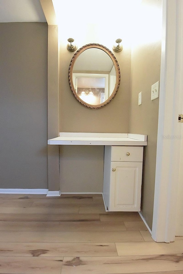 12210 Quail Run Row, Hudson, FL 34667 - bathroom with baseboards, wood finished floors, and vanity