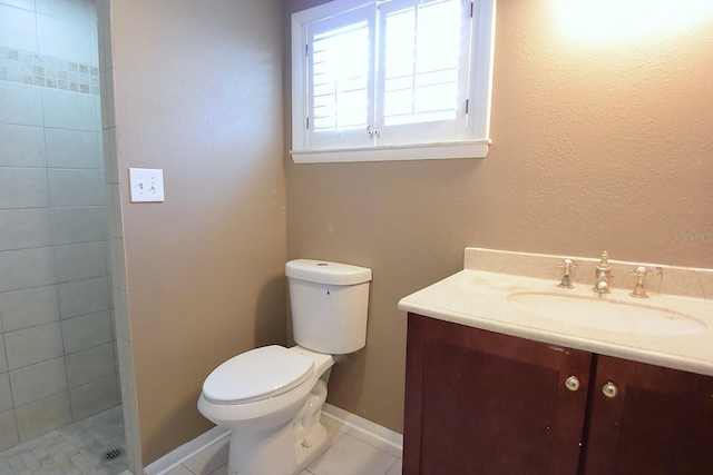 12210 Quail Run Row, Hudson, FL 34667 - bathroom with vanity, tile patterned flooring, a tile shower, and toilet
