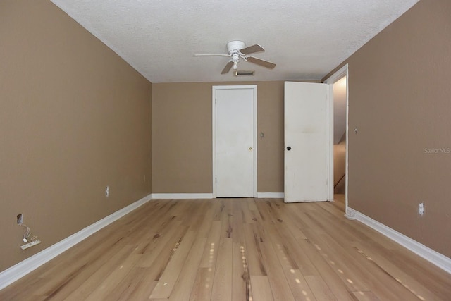 12210 Quail Run Row, Hudson, FL 34667 - unfurnished bedroom with visible vents, baseboards, ceiling fan, light wood-type flooring, and a textured ceiling