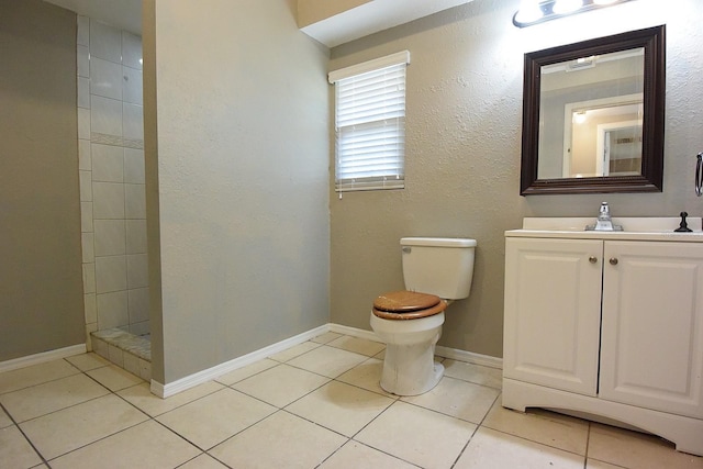 12210 Quail Run Row, Hudson, FL 34667 - full bathroom featuring tile patterned flooring, vanity, toilet, baseboards, and tiled shower