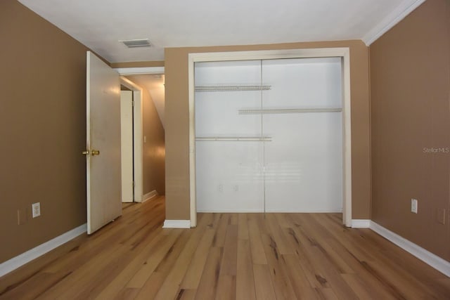 12210 Quail Run Row, Hudson, FL 34667 - unfurnished bedroom with visible vents, baseboards, a closet, and light wood-type flooring