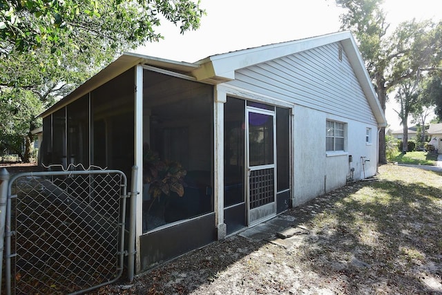 12210 Quail Run Row, Hudson, FL 34667 - view of side of home featuring a sunroom and stucco siding