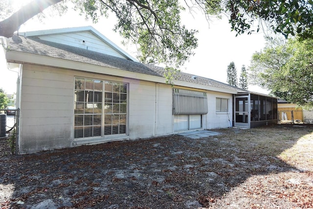 12210 Quail Run Row, Hudson, FL 34667 - rear view of property with roof with shingles, central AC, and a sunroom