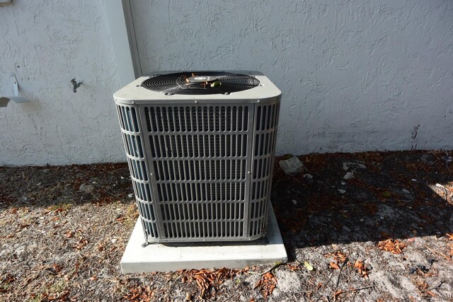 12210 Quail Run Row, Hudson, FL 34667 - details featuring stucco siding and cooling unit