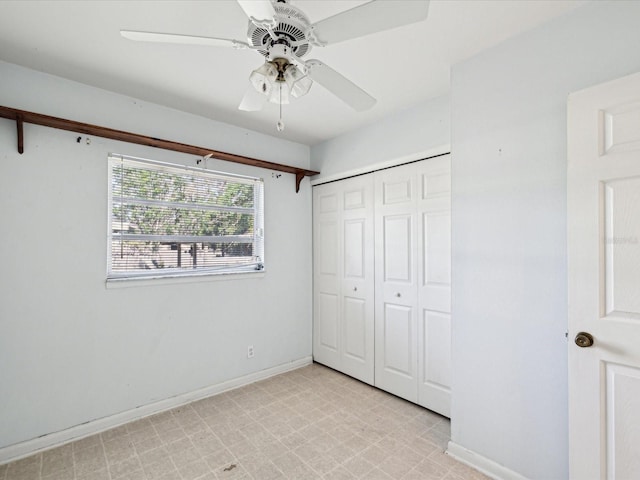 unfurnished bedroom featuring baseboards, ceiling fan, a closet, and light floors