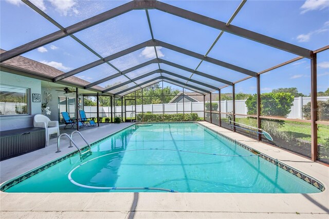 view of swimming pool featuring a fenced backyard, a fenced in pool, a ceiling fan, a patio area, and a lanai