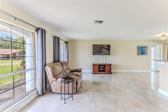 living room with baseboards and visible vents
