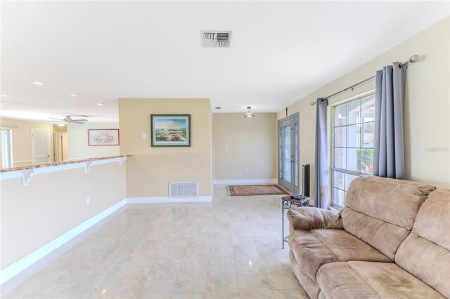 living room with baseboards, ceiling fan, recessed lighting, and visible vents