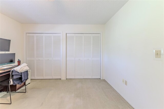 unfurnished office with a textured ceiling and carpet