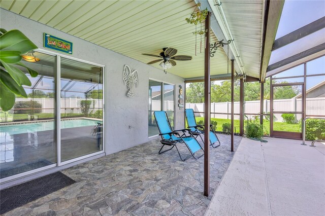sunroom / solarium with plenty of natural light and ceiling fan