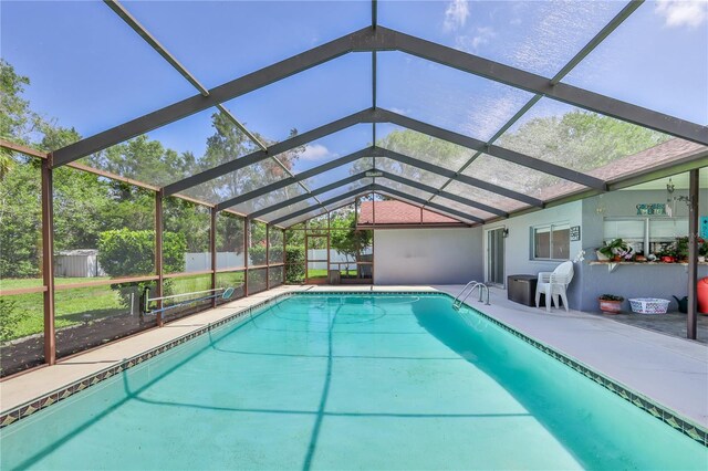 outdoor pool featuring a patio, a lanai, and fence