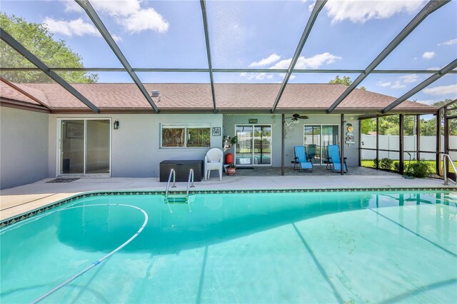 view of swimming pool featuring ceiling fan, fence, a fenced in pool, a patio area, and a lanai