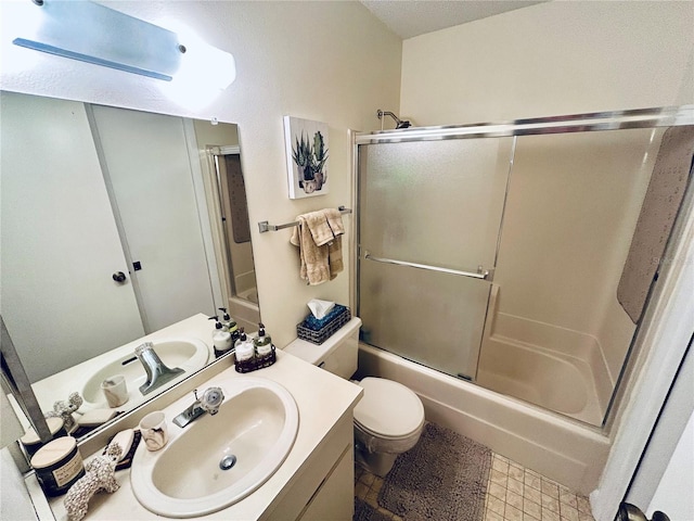 bathroom with vanity, combined bath / shower with glass door, and toilet
