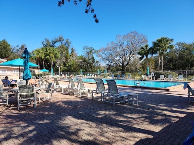 pool featuring a patio and fence
