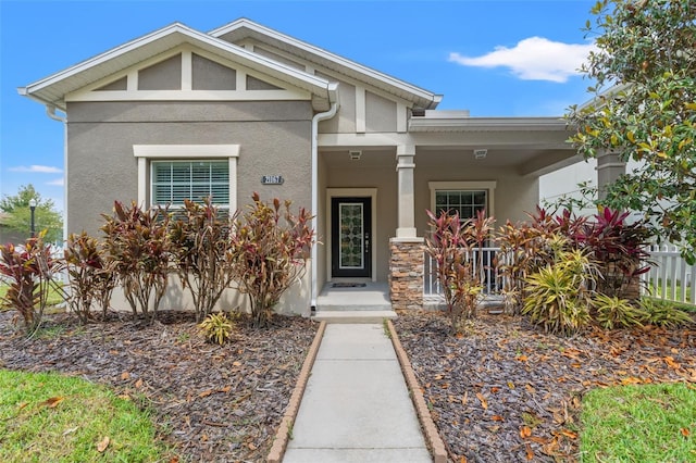 21167 Pleasant Plains Pkwy, Land O Lakes, FL 34637 - craftsman-style home featuring stucco siding and a porch