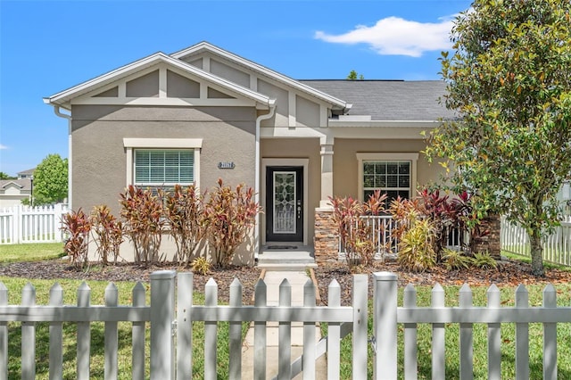 21167 Pleasant Plains Pkwy, Land O Lakes, FL 34637 - craftsman inspired home with covered porch, a fenced front yard, and stucco siding