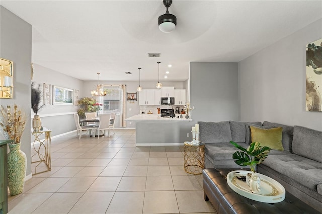 21167 Pleasant Plains Pkwy, Land O Lakes, FL 34637 - living area featuring baseboards, visible vents, light tile patterned floors, and ceiling fan with notable chandelier
