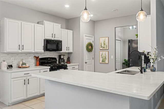 21167 Pleasant Plains Pkwy, Land O Lakes, FL 34637 - kitchen with white cabinetry, black appliances, and tasteful backsplash