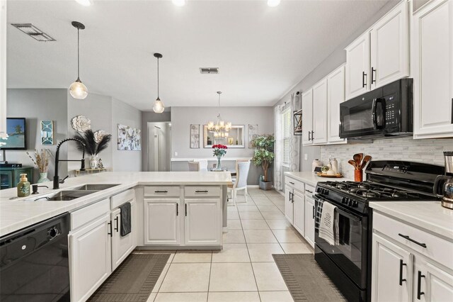 21167 Pleasant Plains Pkwy, Land O Lakes, FL 34637 - kitchen with visible vents, tasteful backsplash, a sink, light tile patterned floors, and black appliances