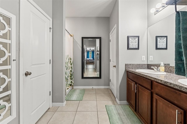21167 Pleasant Plains Pkwy, Land O Lakes, FL 34637 - bathroom featuring double vanity, tile patterned flooring, curtained shower, a sink, and baseboards