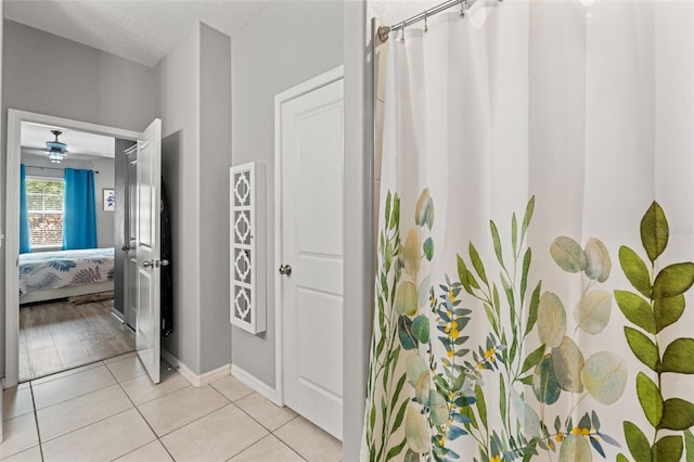 21167 Pleasant Plains Pkwy, Land O Lakes, FL 34637 - bathroom with baseboards, ensuite bathroom, tile patterned flooring, and curtained shower
