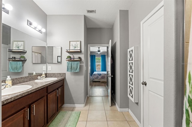 21167 Pleasant Plains Pkwy, Land O Lakes, FL 34637 - ensuite bathroom with double vanity, tile patterned floors, visible vents, and a sink