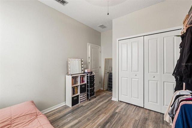 21167 Pleasant Plains Pkwy, Land O Lakes, FL 34637 - bedroom with visible vents, wood finished floors, and a closet