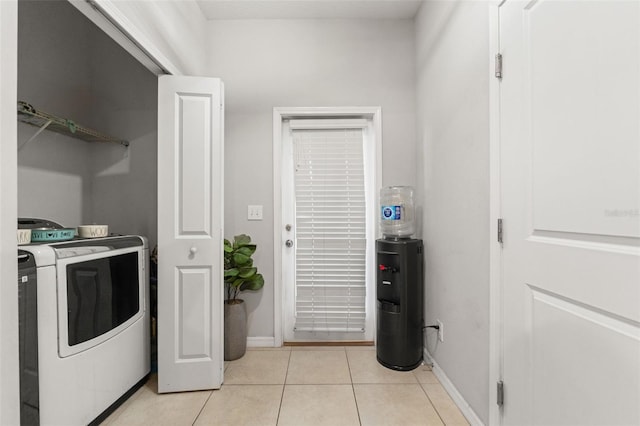 21167 Pleasant Plains Pkwy, Land O Lakes, FL 34637 - washroom with light tile patterned floors, baseboards, laundry area, and washing machine and dryer