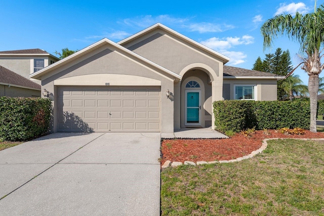 ranch-style house featuring a front lawn, an attached garage, concrete driveway, and stucco siding