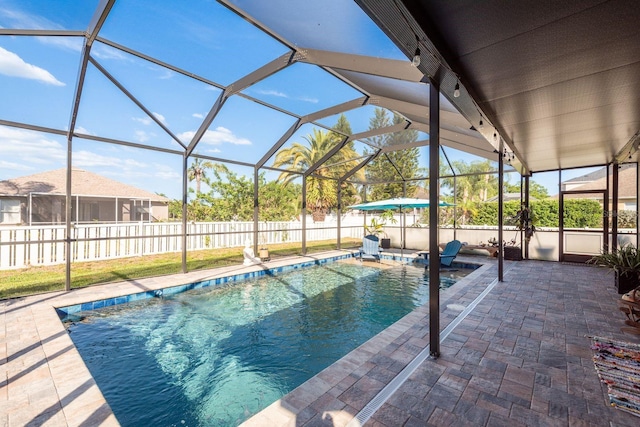 view of pool featuring a patio, a fenced backyard, glass enclosure, and a fenced in pool