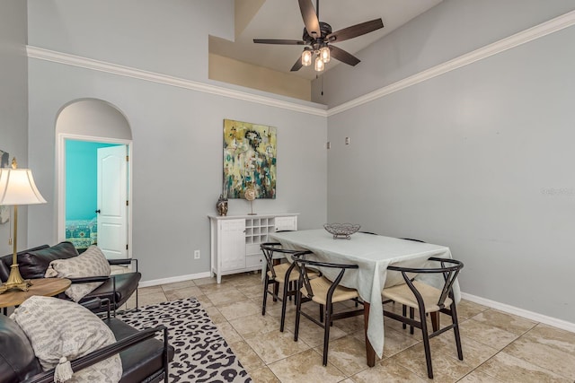 dining space with baseboards, ceiling fan, ornamental molding, and light tile patterned flooring