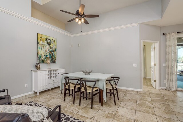 dining area with light tile patterned floors, baseboards, and a ceiling fan