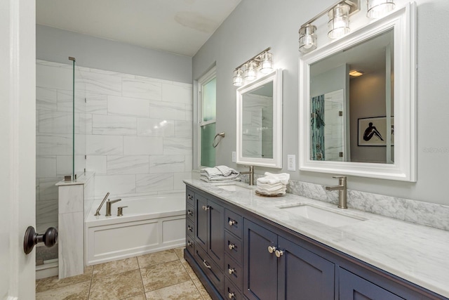 full bathroom with a bathing tub, double vanity, and a sink