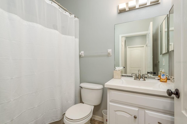 bathroom featuring vanity, baseboards, and toilet