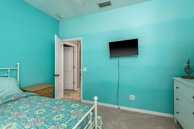 bedroom with visible vents, a ceiling fan, baseboards, and light carpet