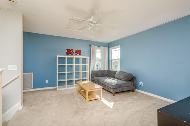 living area featuring baseboards, ceiling fan, carpet flooring, and visible vents