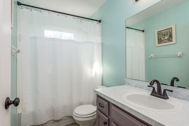 bathroom with vanity, curtained shower, and toilet