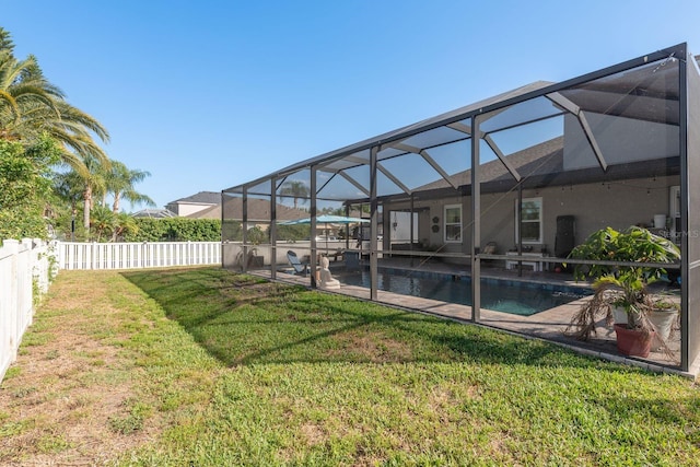 view of yard with glass enclosure, a patio, a fenced in pool, and a fenced backyard