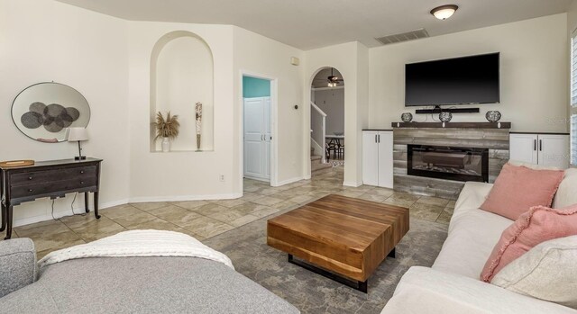 1810 Winsloe Dr, Trinity, FL 34655 - living room featuring ceiling fan, stairway, tile patterned flooring, and a glass covered fireplace