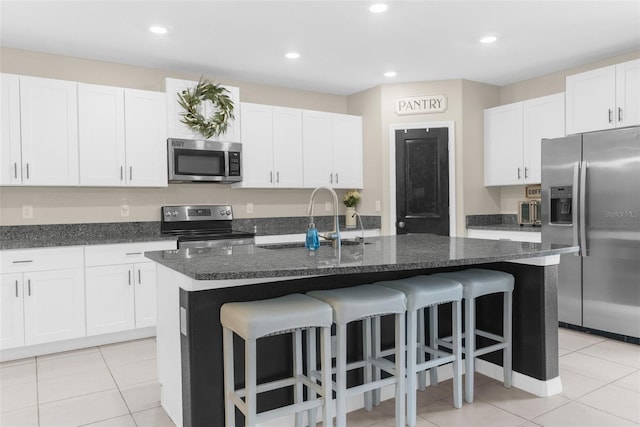 2132 Shining Azul Way, Lutz, FL 33558 - kitchen featuring stainless steel appliances, a sink, light tile patterned flooring, a kitchen breakfast bar, and recessed lighting