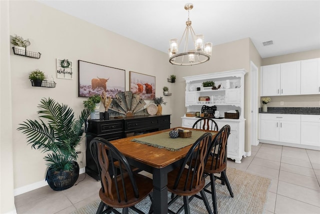2132 Shining Azul Way, Lutz, FL 33558 - dining area with light tile patterned floors, a chandelier, and baseboards